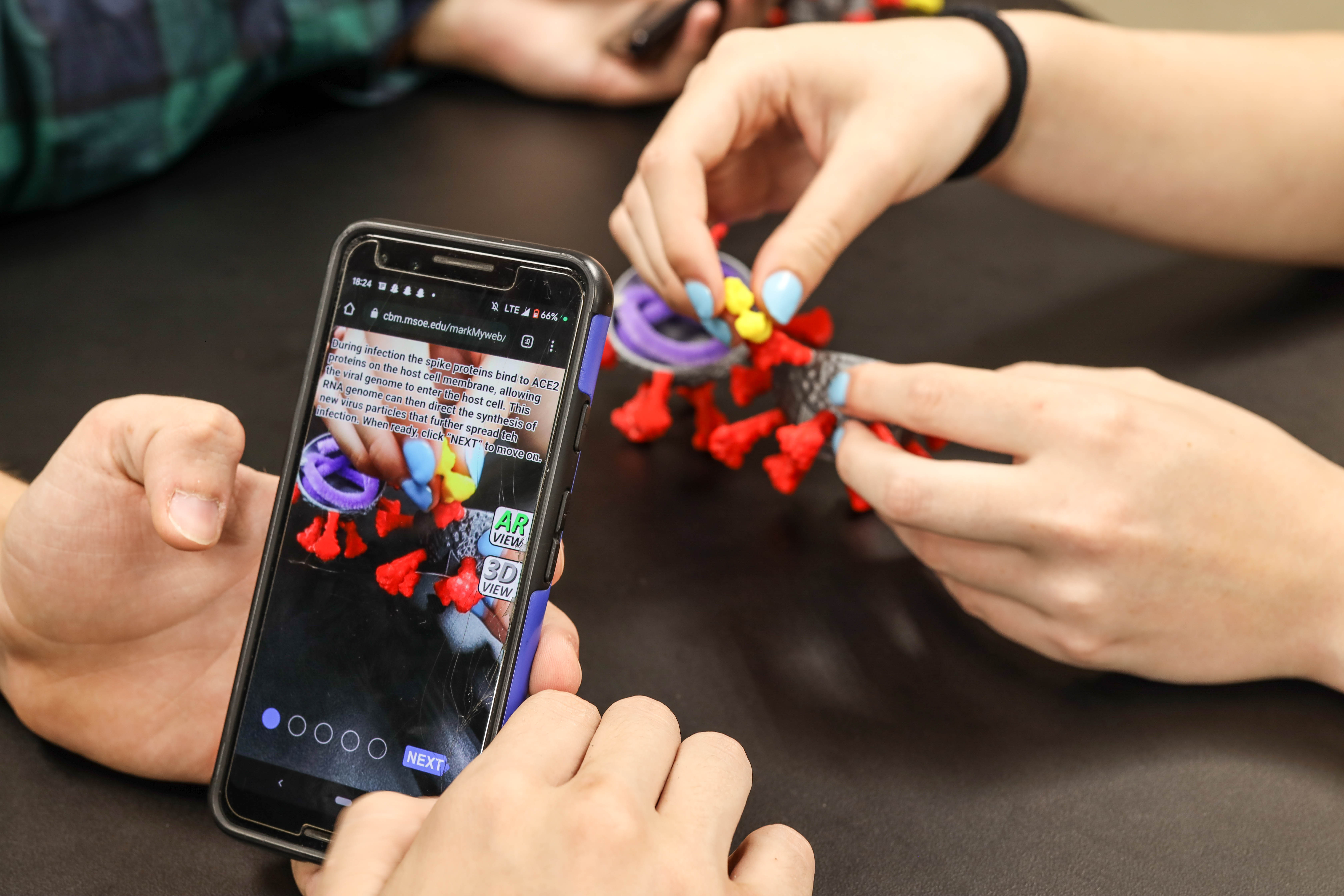 ARCV_A_hands_phone_antibody